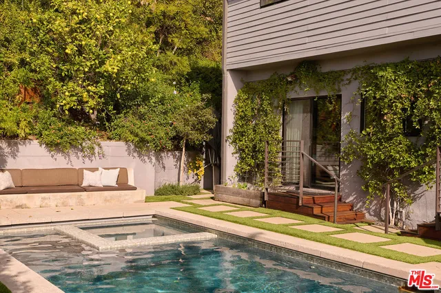a spacious bedroom with a bed and a potted plant