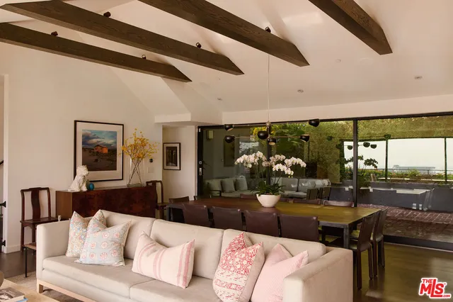 a living room with furniture and a floor to ceiling window