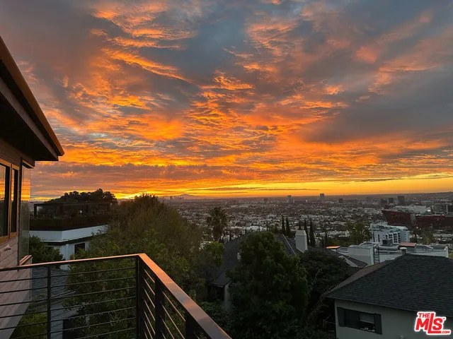 a bedroom with a bed and a lamp on dresser