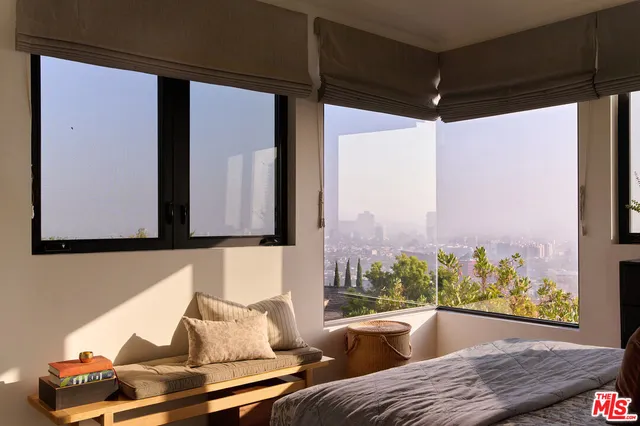 a room with lots of furniture and a book shelf