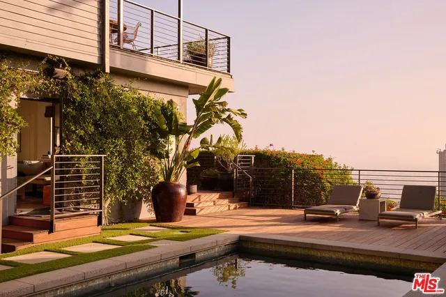 a terrace with outdoor seating and city view