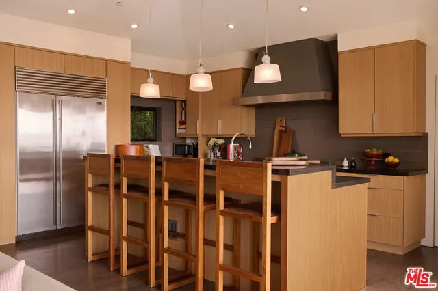 a kitchen with cabinets a sink and appliances