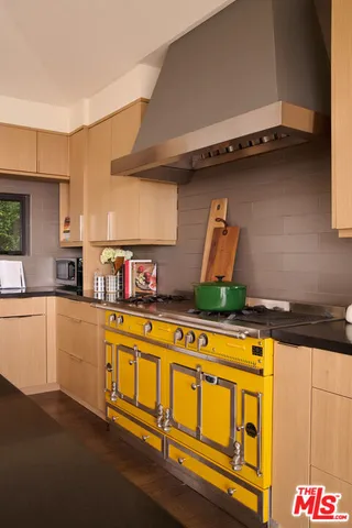 a kitchen with stainless steel appliances granite countertop a stove and a sink