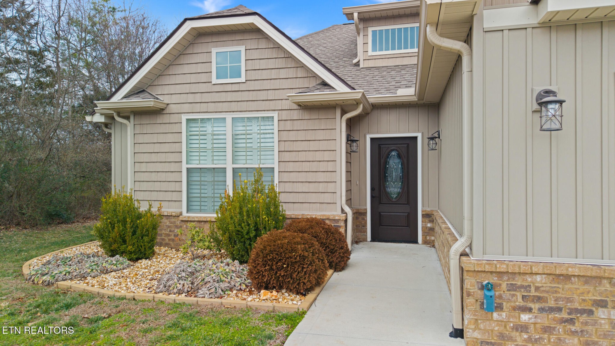 129 Ogana Way Loudon, TN 37774 - Photo 3 of 32 a front view of a house with garden
