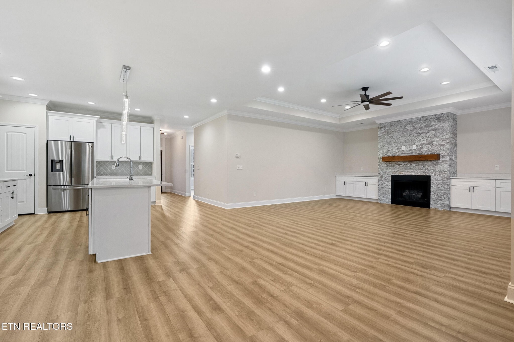 129 Ogana Way Loudon, TN 37774 - Photo 7 of 32 a view of kitchen and hall with stainless steel appliances wooden floor