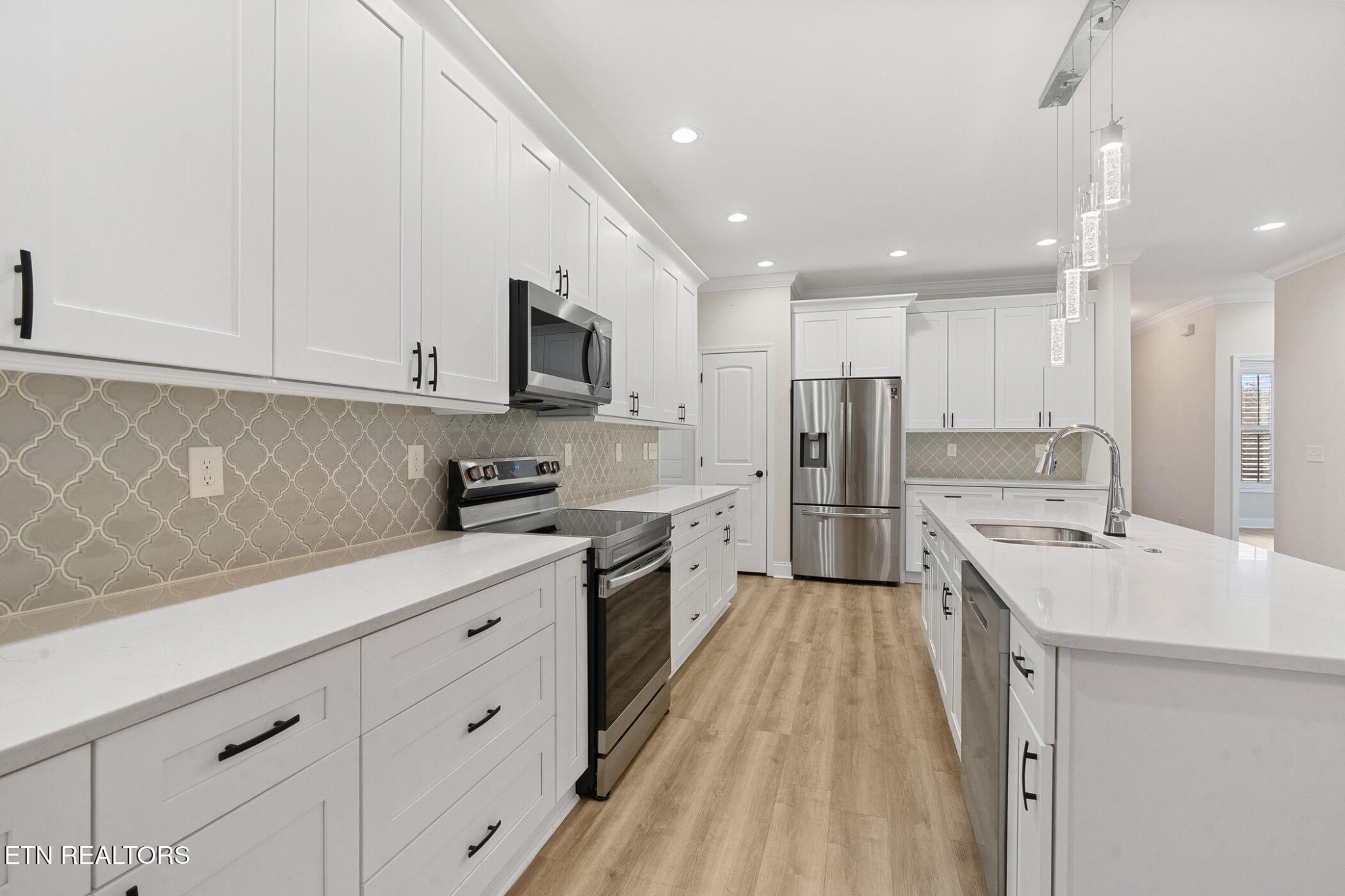 129 Ogana Way Loudon, TN 37774 - Photo 10 of 32 a kitchen with stainless steel appliances sink stove refrigerator and cabinets