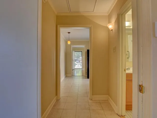 a view of a hallway with wooden shelves