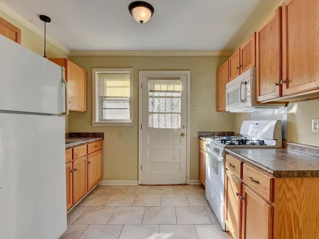 a kitchen with stainless steel appliances granite countertop a stove a refrigerator and a sink