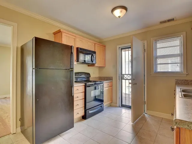 a kitchen with a refrigerator and a stove