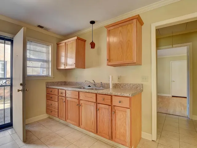 a bathroom with a granite countertop sink a mirror and a shower