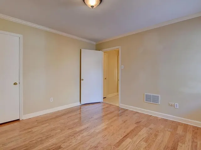 a view of an empty room with wooden floor