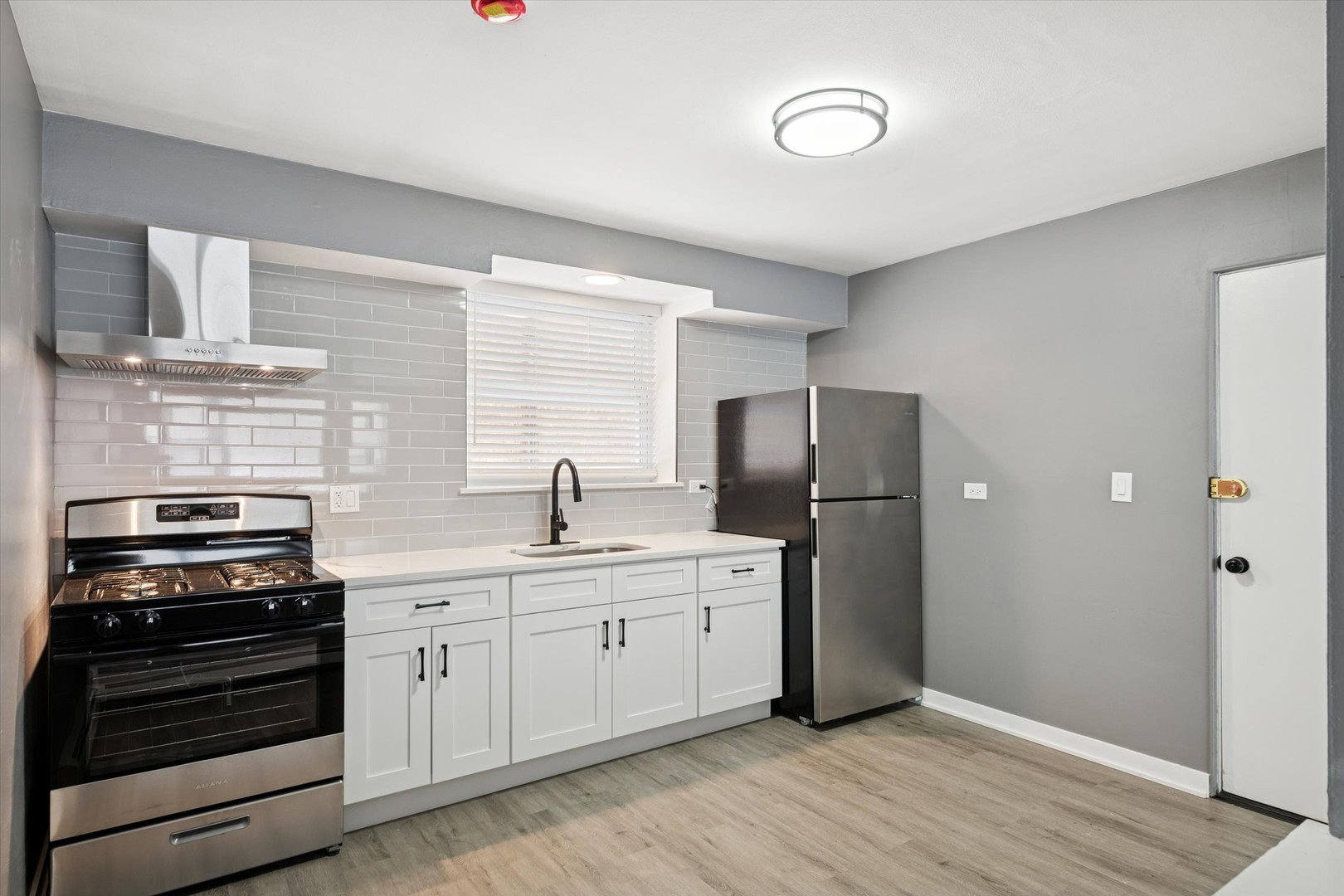 1910 16th Avenue, Unit 3 Broadview, IL 60155 - Photo 3 of 14 a kitchen with stainless steel appliances a stove sink and refrigerator