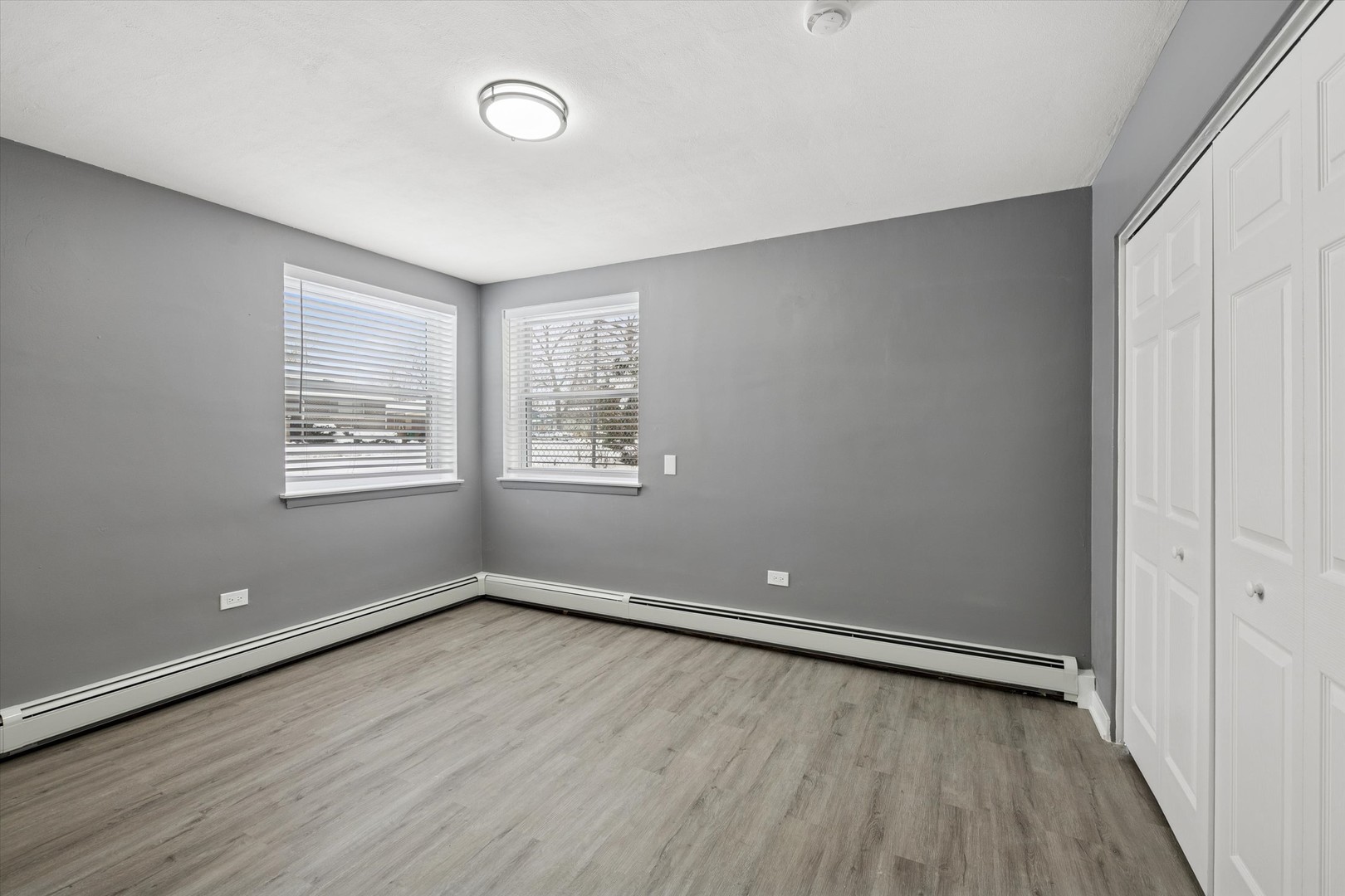 1910 16th Avenue, Unit 3 Broadview, IL 60155 - Photo 8 of 14 an empty room with wooden floor and windows