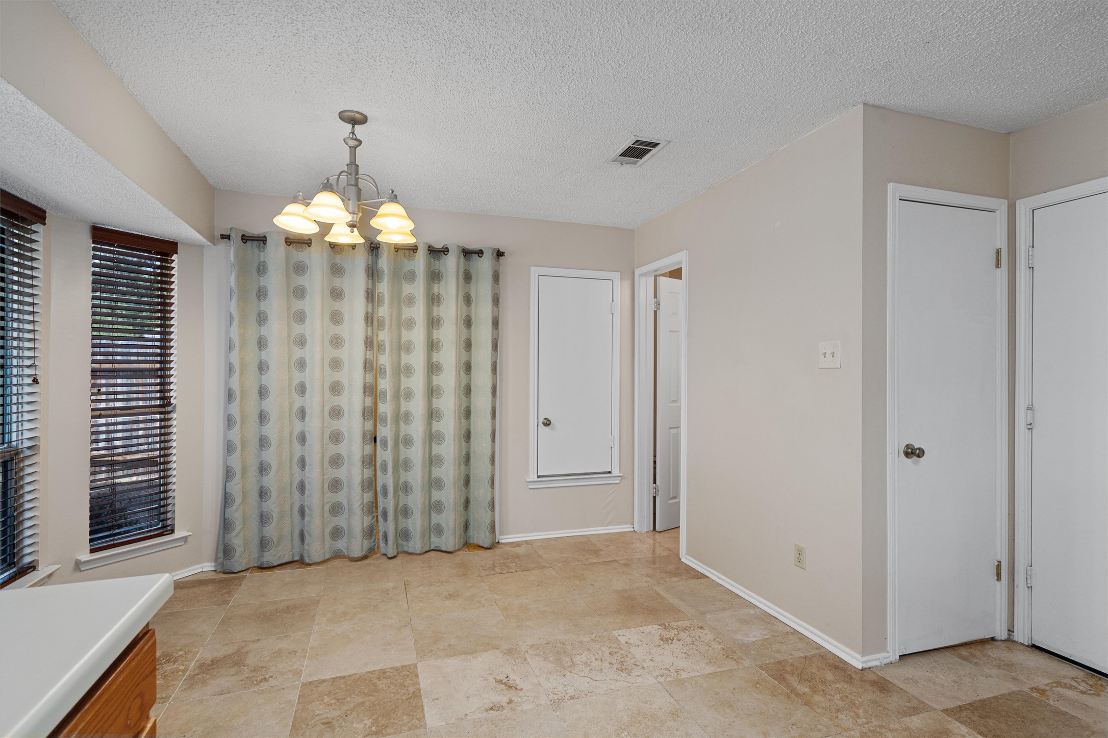 4700 Fallenash Drive Austin, TX 78725 - Photo 16 of 33 wooden floor in an empty room with a chandelier fan