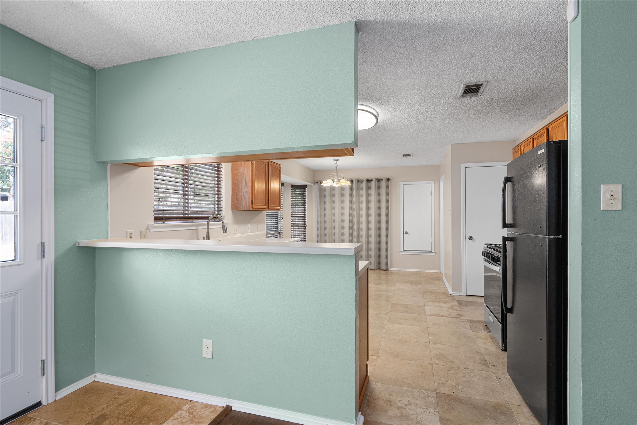 4700 Fallenash Drive Austin, TX 78725 - Photo 10 of 33 a kitchen with stainless steel appliances a refrigerator and a sink