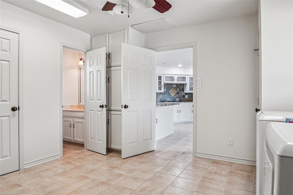 1006 Cochran Road Argyle, TX 76226 - Photo 23 of 40 a view of a kitchen with a refrigerator and a sink
