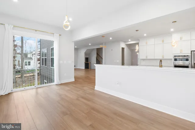 a view of a kitchen with wooden floor and a window
