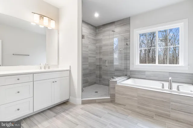 a bathroom with a bathtub shower and sink