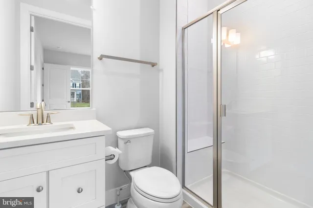 a white toilet sitting next to a bathroom sink