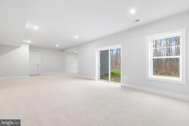 an empty room with windows and entrance