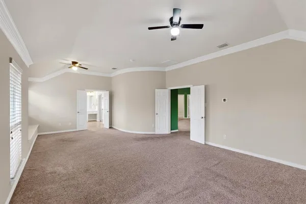 a view of an empty room with a ceiling fan