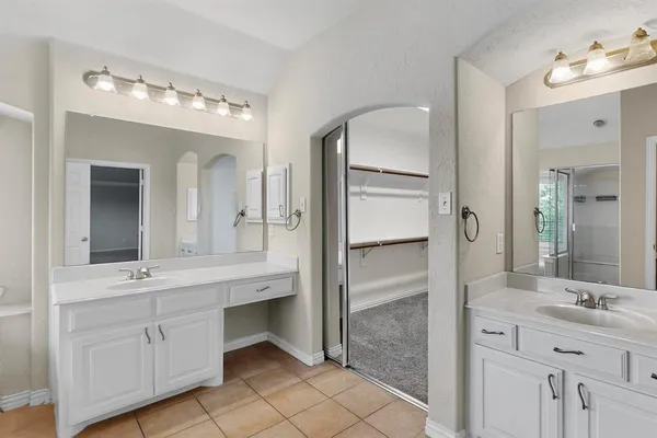 a bathroom with a double vanity sink and mirror