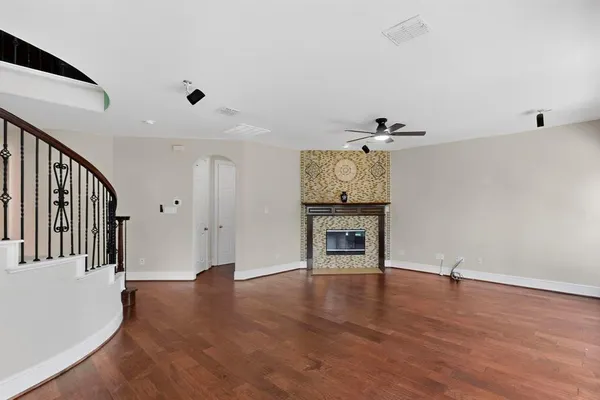 a view of a livingroom with wooden floor and furniture