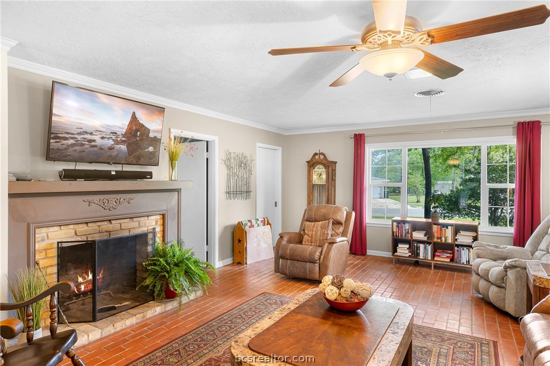 800 Esther Boulevard Bryan, TX 77802 - Photo 12 of 37 a living room with furniture a fireplace and a large window
