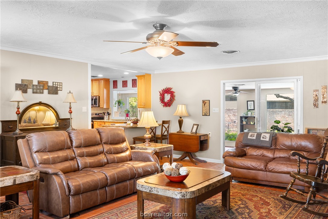 800 Esther Boulevard Bryan, TX 77802 - Photo 14 of 37 a living room with furniture a chandelier and a window