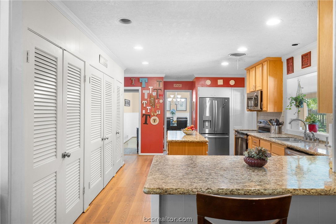 800 Esther Boulevard Bryan, TX 77802 - Photo 18 of 37 a kitchen with stainless steel appliances granite countertop a sink and refrigerator