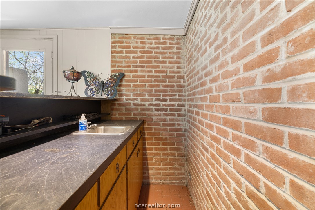 800 Esther Boulevard Bryan, TX 77802 - Photo 24 of 37 a bathroom with a granite countertop sink and a mirror