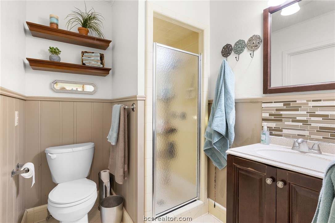 800 Esther Boulevard Bryan, TX 77802 - Photo 26 of 37 a bathroom with a toilet sink and mirror