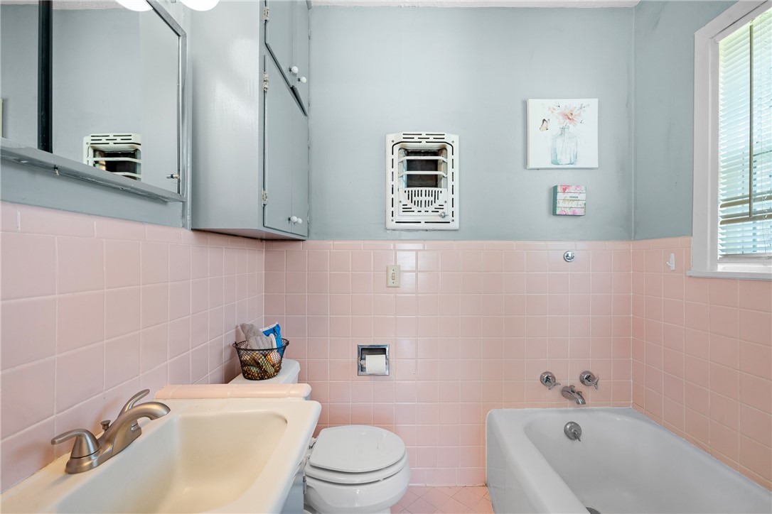 800 Esther Boulevard Bryan, TX 77802 - Photo 28 of 37 a bathroom with a sink a toilet and a bathtub