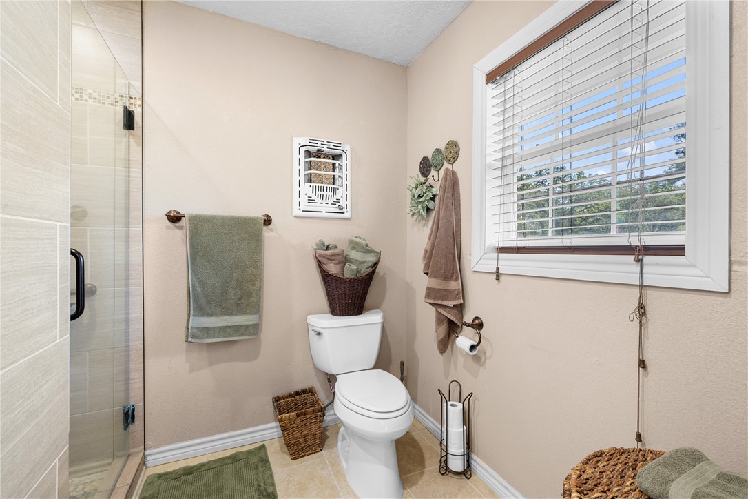800 Esther Boulevard Bryan, TX 77802 - Photo 30 of 37 a white toilet sitting next to a bathroom sink