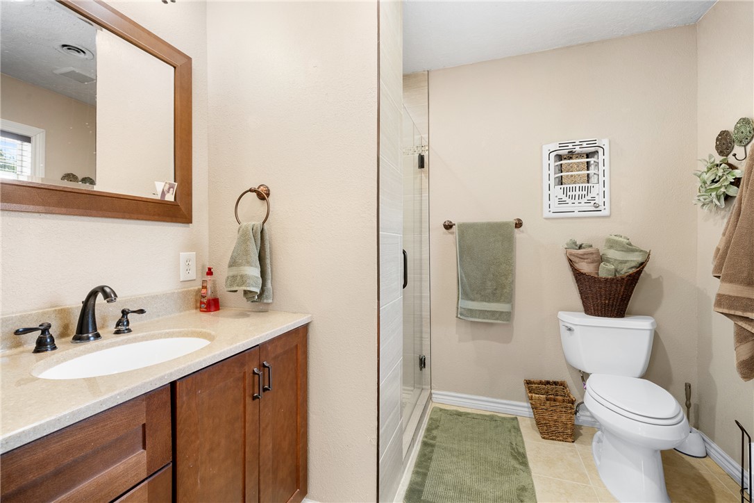 800 Esther Boulevard Bryan, TX 77802 - Photo 31 of 37 a bathroom with a toilet sink and mirror