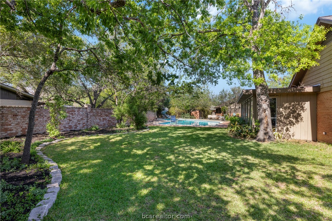 800 Esther Boulevard Bryan, TX 77802 - Photo 8 of 37 a view of a yard with plants and trees