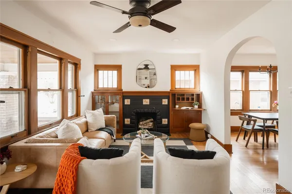 a living room with furniture and floor to ceiling windows