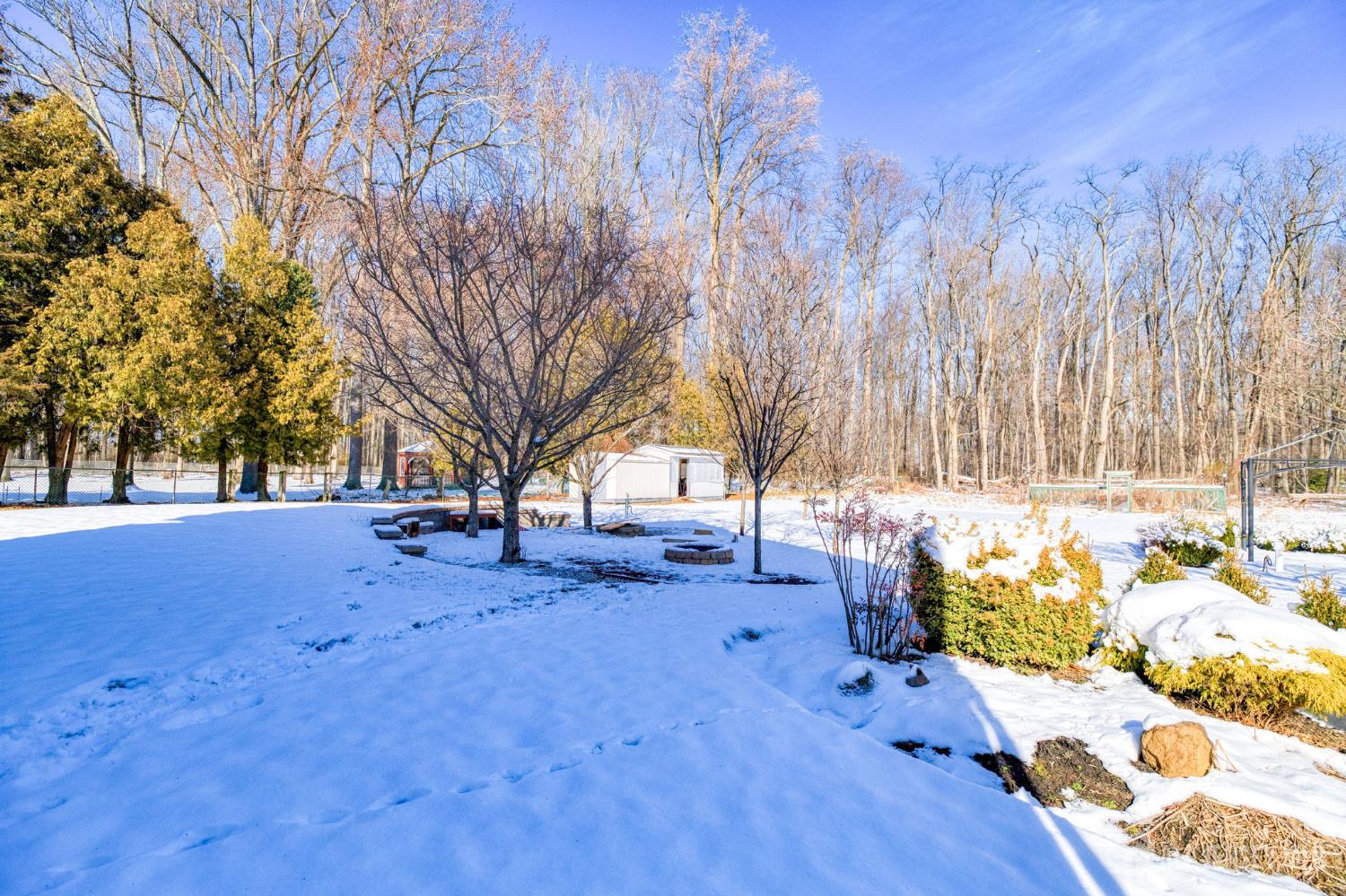 25 Davidson's Mill Road North Brunswick, NJ 08902 - Photo 38 of 56 a wooden bench sitting in middle of snow