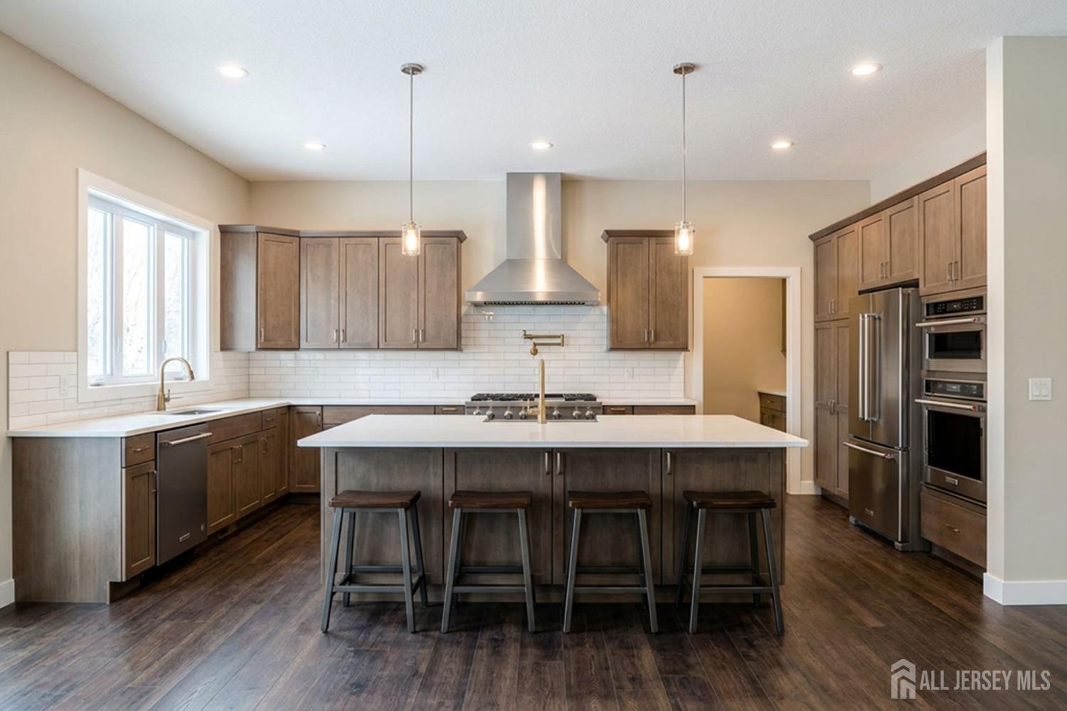 25 Davidson's Mill Road North Brunswick, NJ 08902 - Photo 6 of 56 a kitchen with kitchen island a dining table chairs stainless steel appliances and cabinets