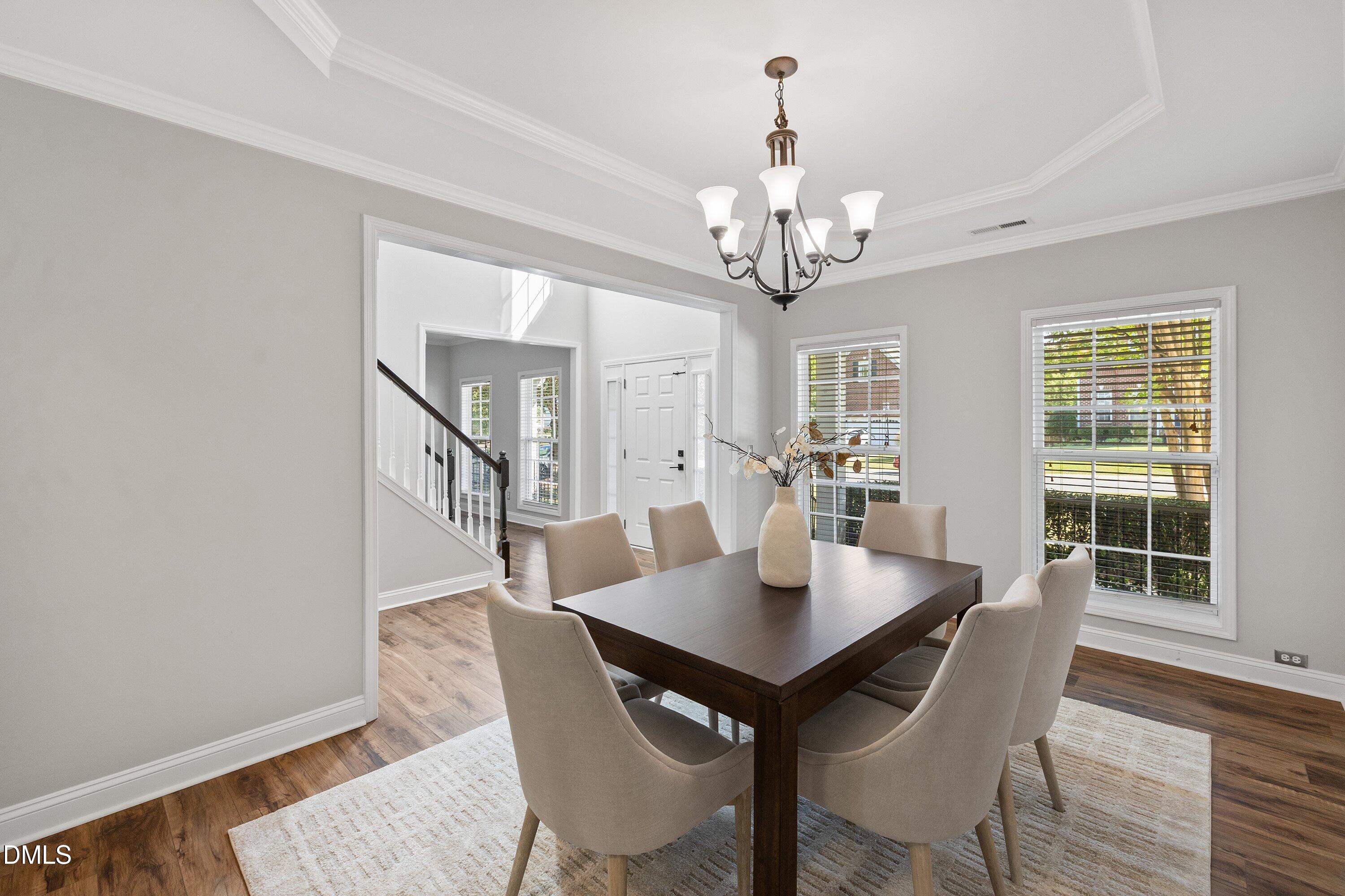 3717 Windmeade Road Wake Forest, NC 27587 - Photo 10 of 51 a view of a dining room with furniture and wooden floor