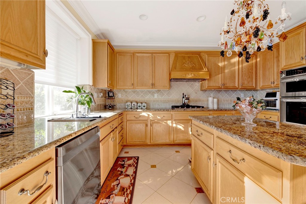 11233 Ravenna Lane Porter Ranch, CA 91326 - Photo 14 of 46 a kitchen with stainless steel appliances granite countertop a sink a stove and a microwave