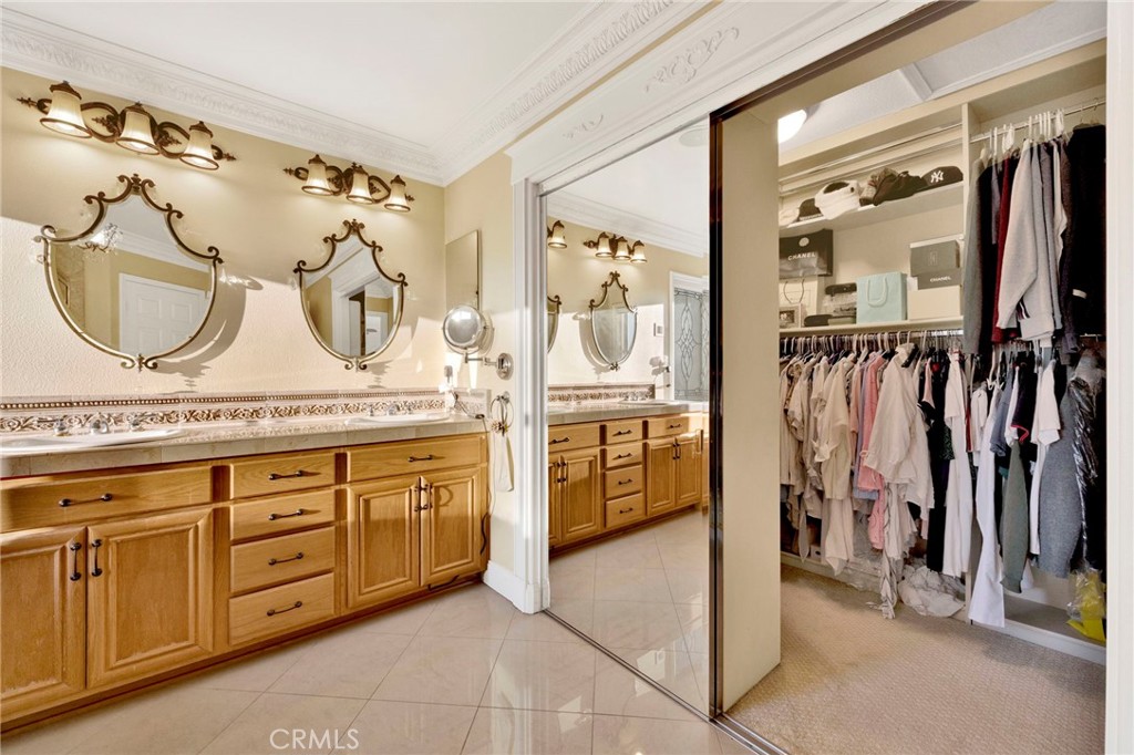 11233 Ravenna Lane Porter Ranch, CA 91326 - Photo 23 of 46 a bathroom with a double vanity sink and a mirror