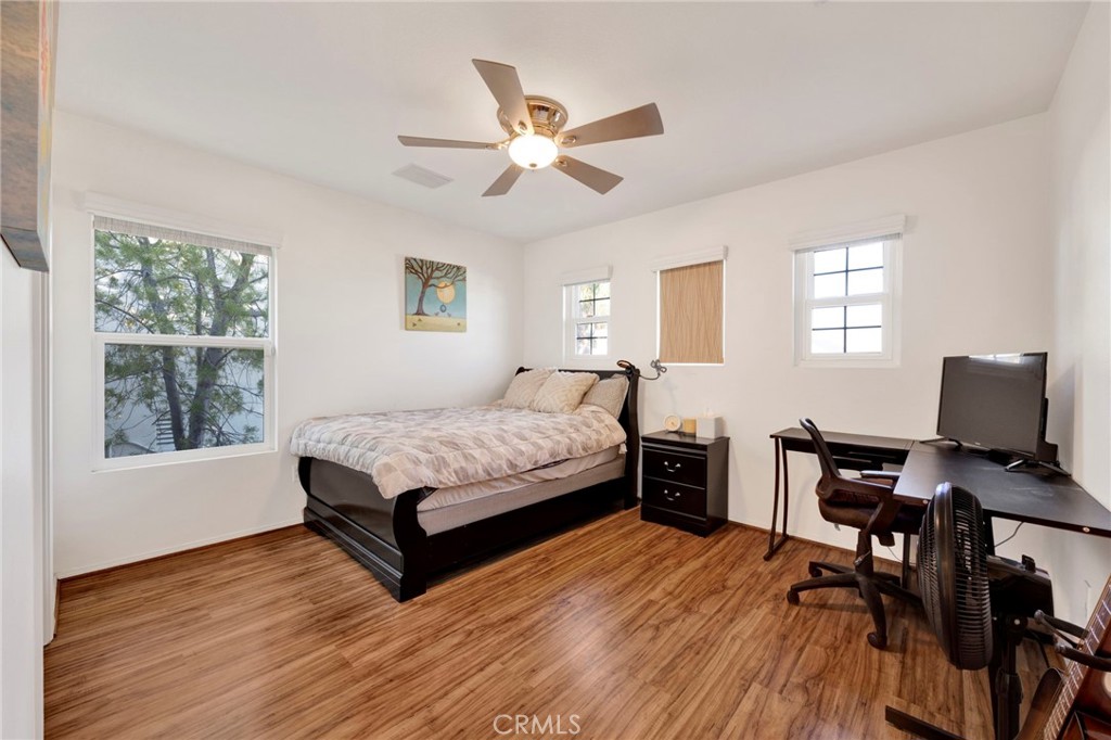 11233 Ravenna Lane Porter Ranch, CA 91326 - Photo 26 of 46 a bedroom with a bed wooden floor and a window