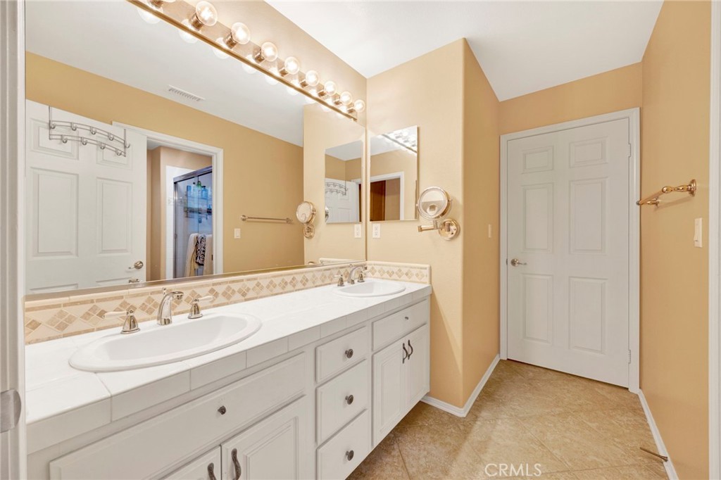 11233 Ravenna Lane Porter Ranch, CA 91326 - Photo 27 of 46 a spacious bathroom with a double vanity sink mirror and
