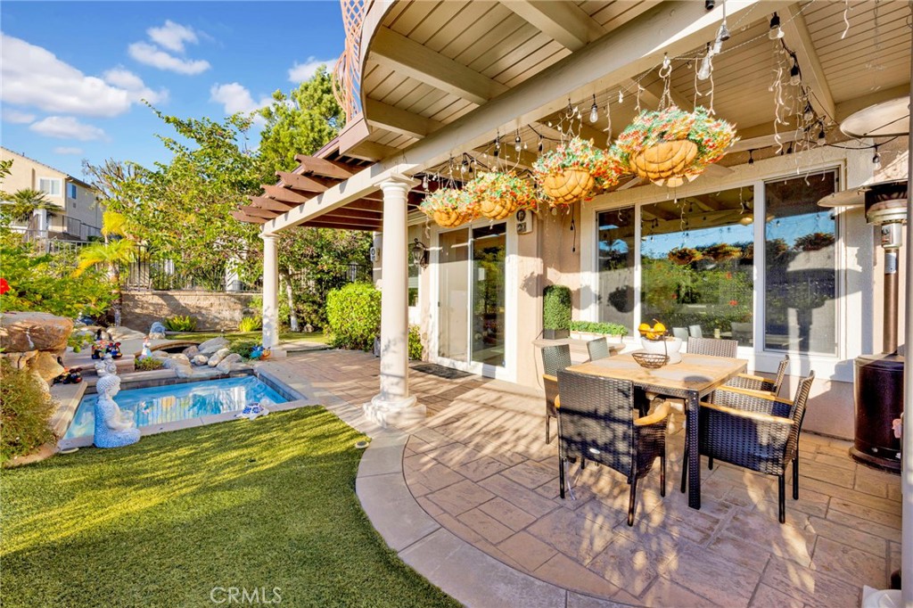 11233 Ravenna Lane Porter Ranch, CA 91326 - Photo 33 of 46 a view of a patio with dining table and chairs with plants