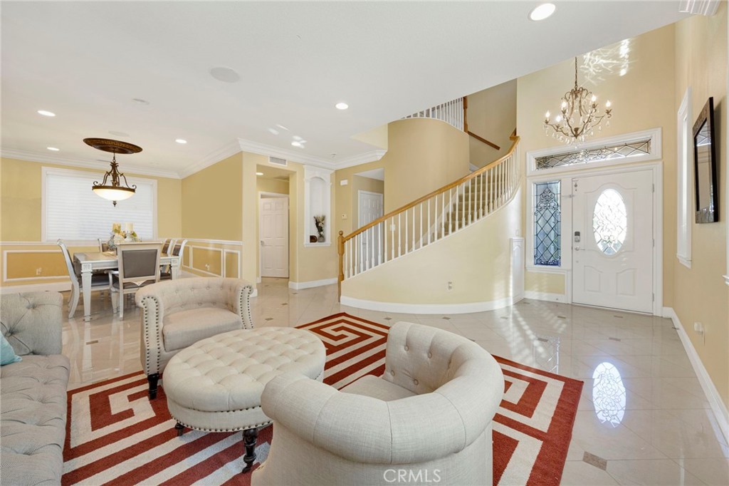 11233 Ravenna Lane Porter Ranch, CA 91326 - Photo 7 of 46 a living room with furniture and a chandelier
