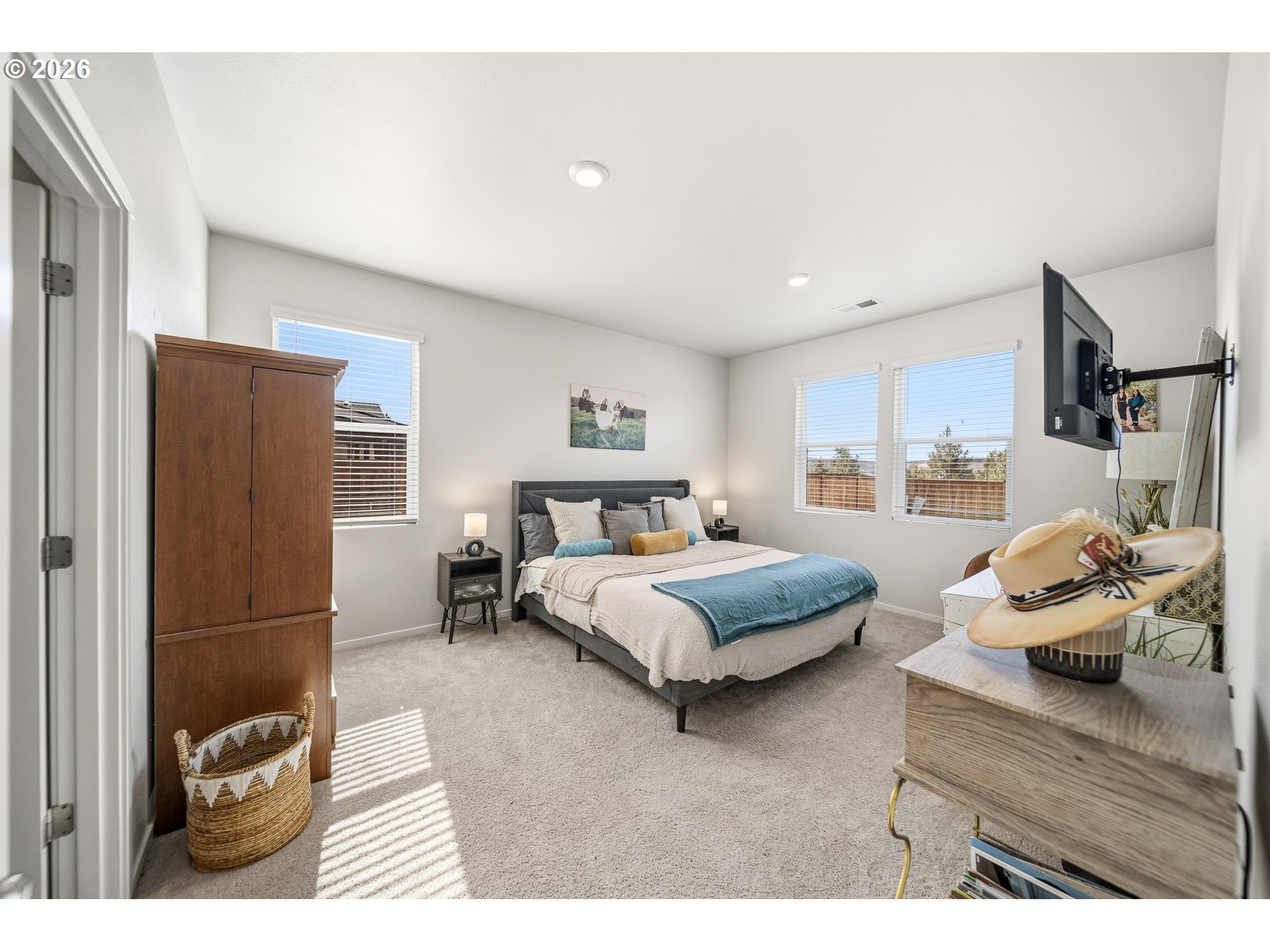 597 Northeast Union Loop Prineville, OR 97754 - Photo 13 of 22 a bedroom with a bed and a refrigerator