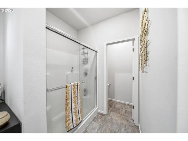 a bathroom with a shower and a glass door