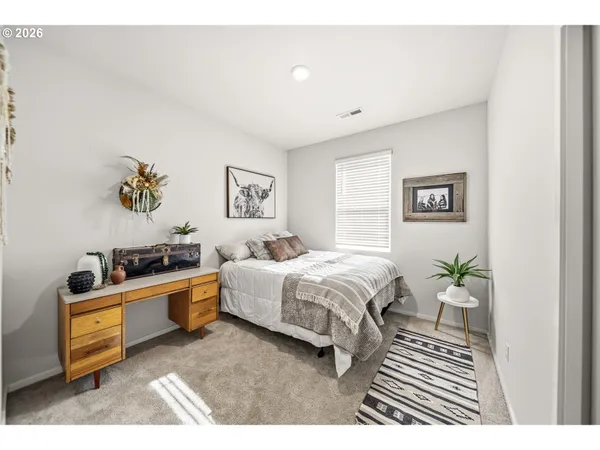 a spacious bedroom with a bed and a couch