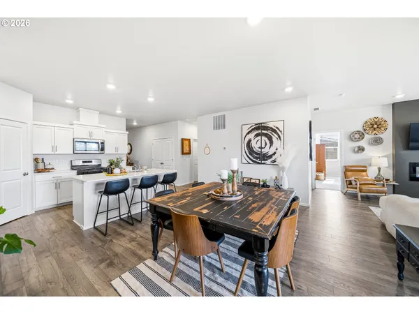 a living room with lots of furniture and kitchen view